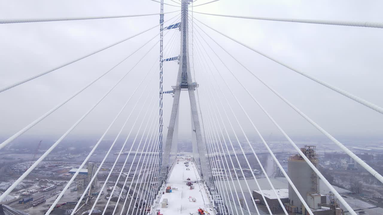 Gordie Howe Bridge tower with loose cable lines in winter
