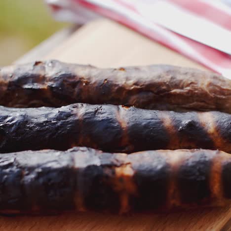 three charred sausages outside