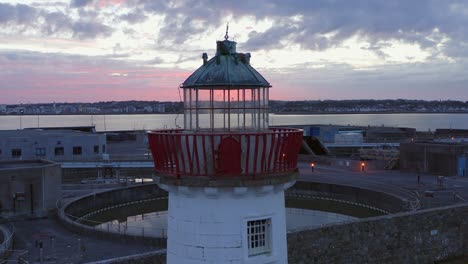 aerial shot of mutton island lighthouse in galway on a cloudy evening