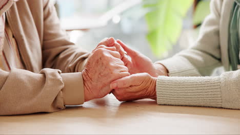 elderly couple holding hands