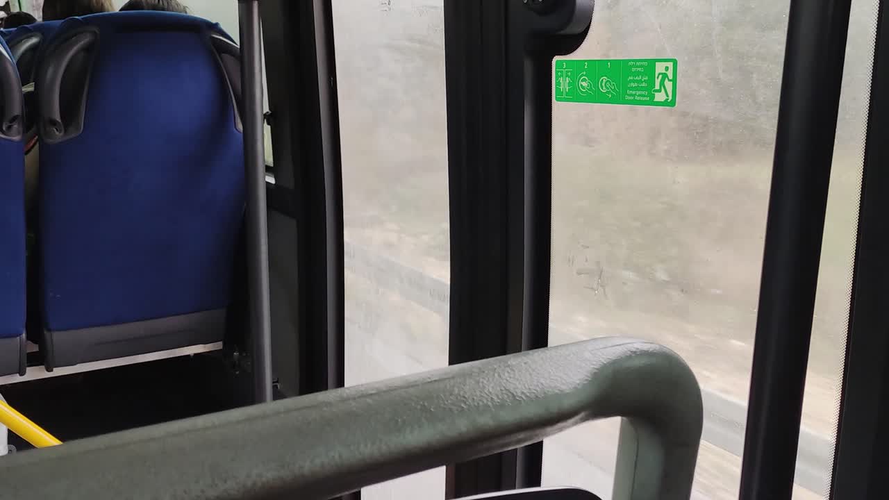 The bus is empty. The seats are blue. Transportation in road.