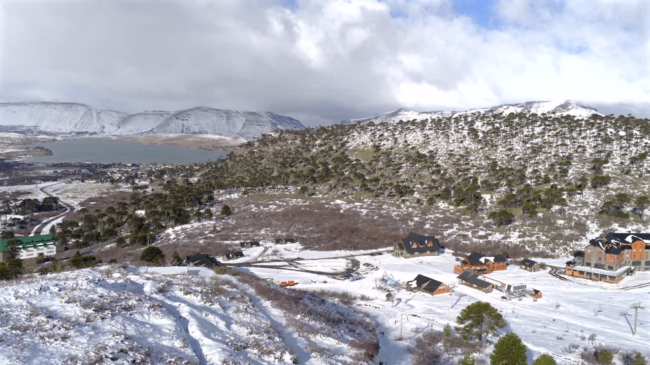 Snowy mountain suburban environment with houses near Caviahue Ski Resort from above, Caviahue-Copahue, Nequén Province, Argentina