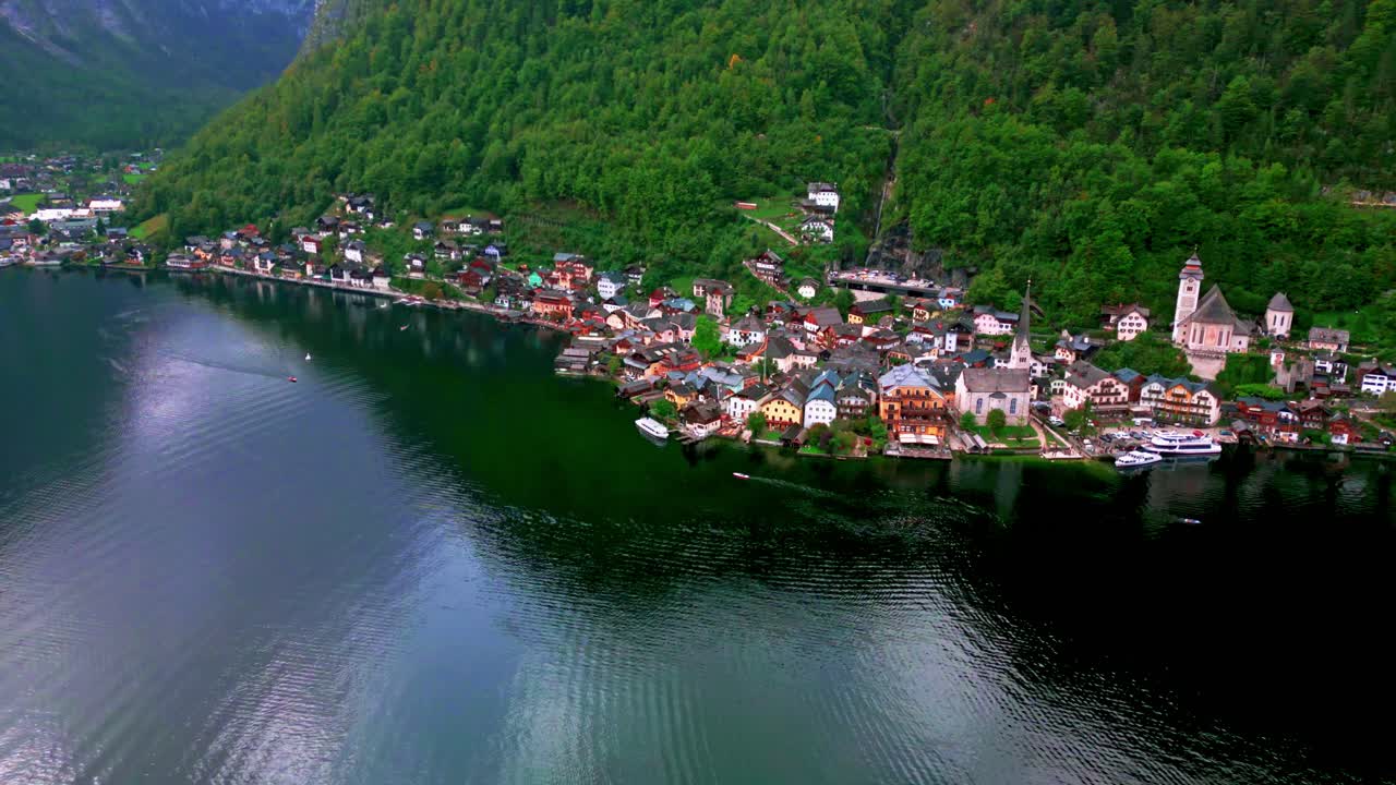 Hallstatt's allure unfolds in our 4K drone footage, revealing quaint houses against a backdrop of stunning mountains