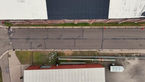 Direct-aerial-of-a-small-street,-tracking-outward