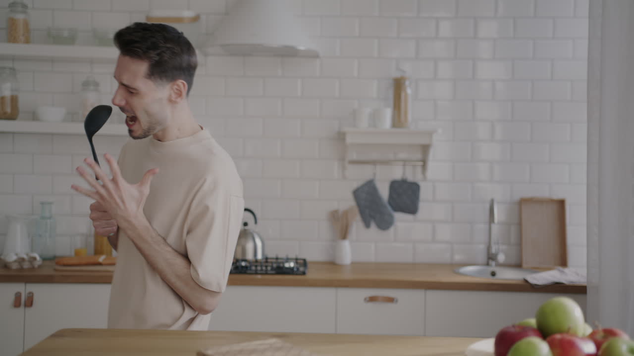 Man Singing and Dancing in Kitchen