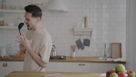 man singing and dancing in kitchen