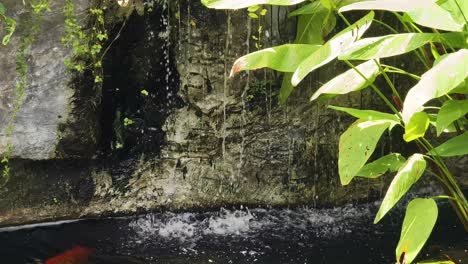 artificial waterfall feature in a garden pond