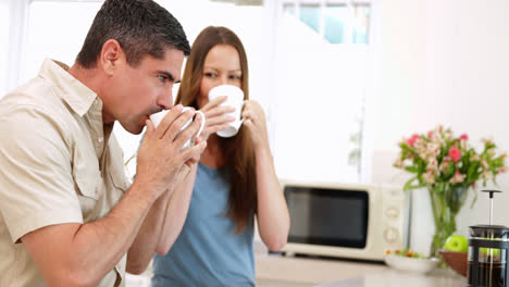 smiling couple drinking coffee together
