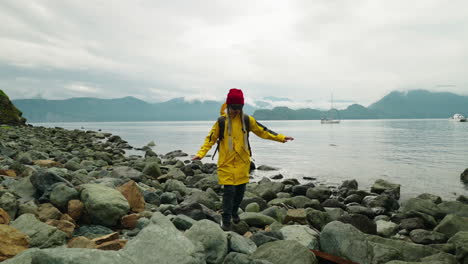 person hiking on a rocky beach