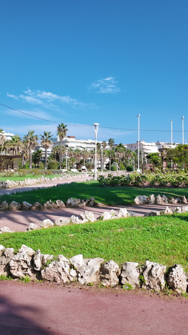 A walk through Square du 8 mai 1945 in Cannes, France in daylight. Vertical