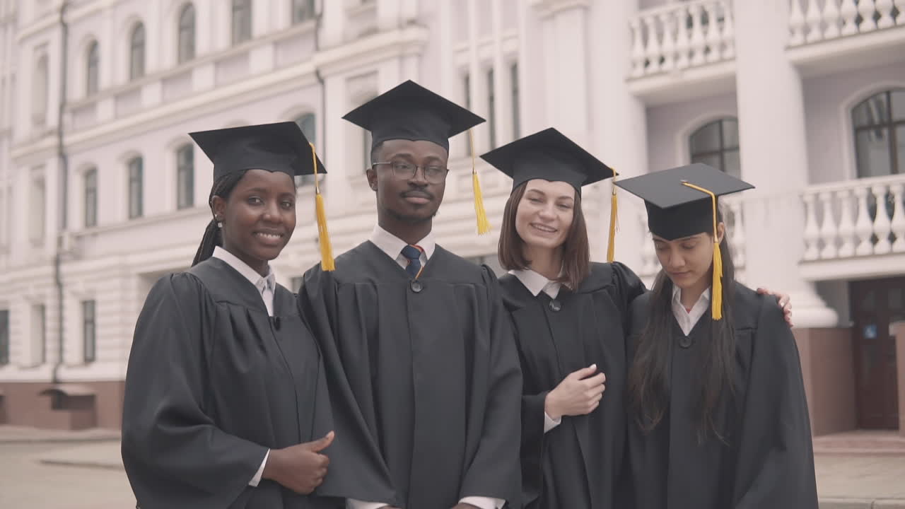 Multicultural Group Of Graduate Students Posing For A Photo And Thumbing Up