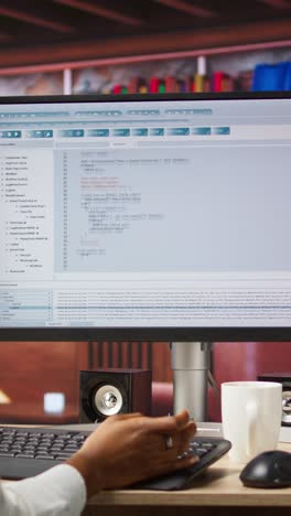 Vertical video IT expert in home office working with code editor