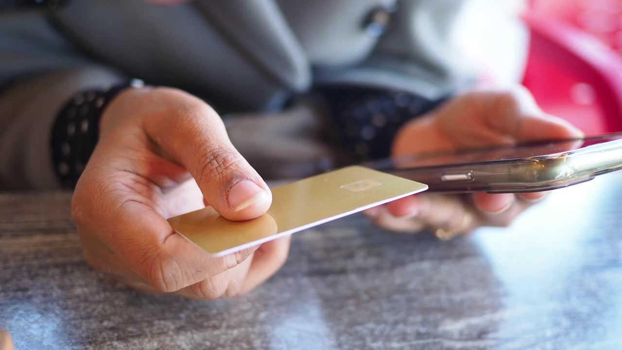 Person Holding Credit Card and Smartphone for Online Payment