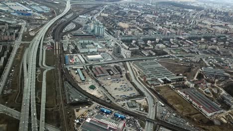 aerial view of an urban area with highways, railways, and industrial zone