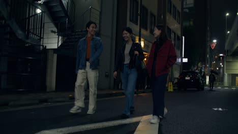 friends walking through a night city street