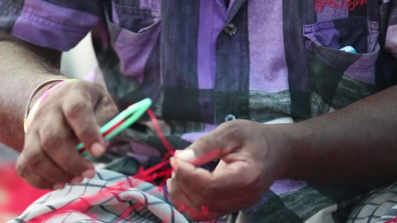 un hombre arreglando una vieja red de pesca al aire libre