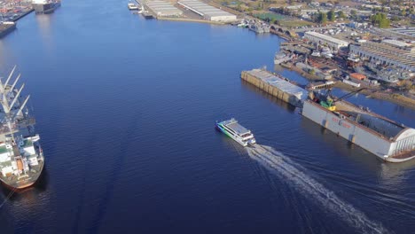 San-Francisco-Alameda-ferry-entering-Oakland-maritime-cargo-port-aerial-view-orbiting