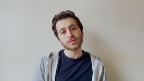 young male student listening intently whilst looking directly into camera