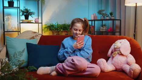 young child kid girl texting share messages content on smartphone social media applications online