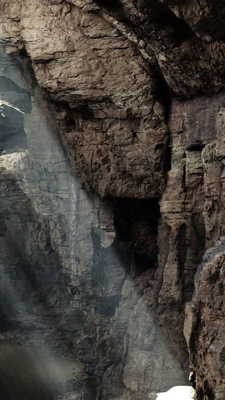 Light shines through a canyon on a bright day near rocky formations