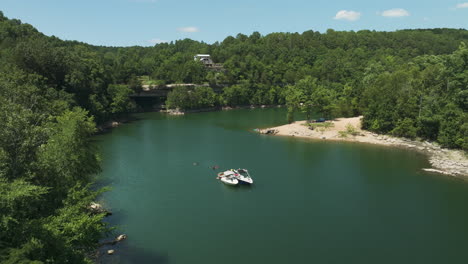 small boats tied together on beaver lake, people enjoying beautiful day