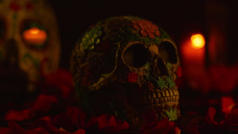 close up on still life of decorated skull surrounded by candles and flower petals celebrating mexican holiday of dia de muertos or day of the dead 1