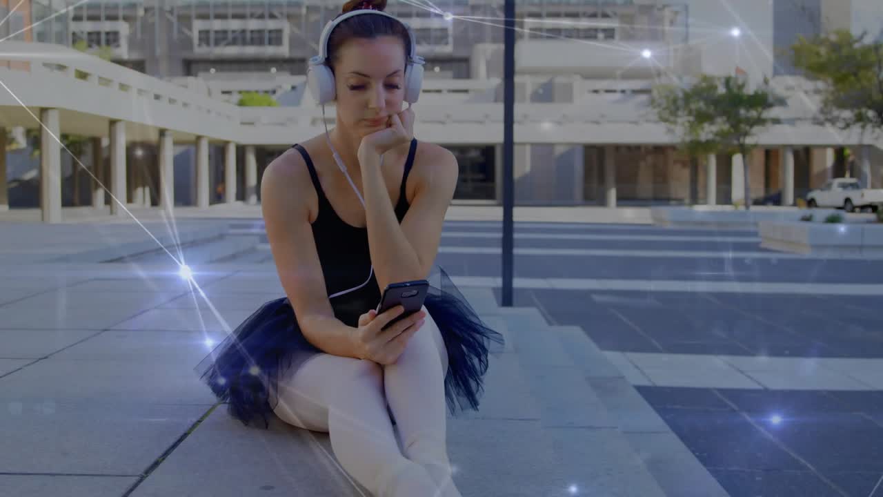 Ballet dancer sitting plaza steps, glancing at phone and starting network overlay while listening