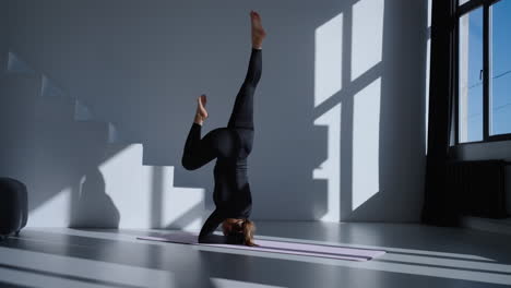 woman practicing yoga at home