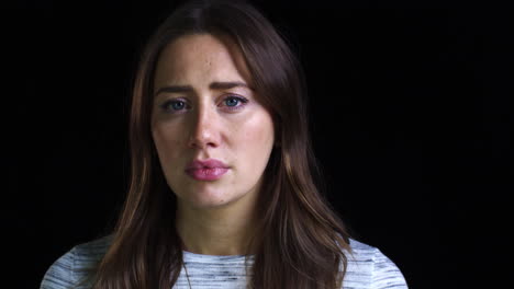 Close-Up-Of-Unhappy-Young-Woman-Looking-Sadly-Into-Camera