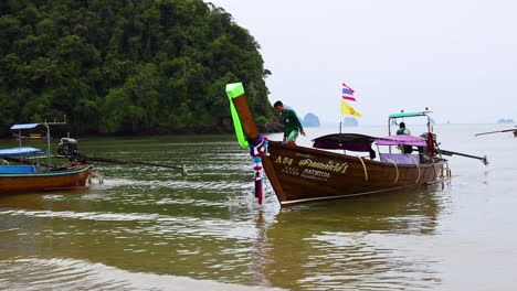 longtail boats at a tropical beach in thailand