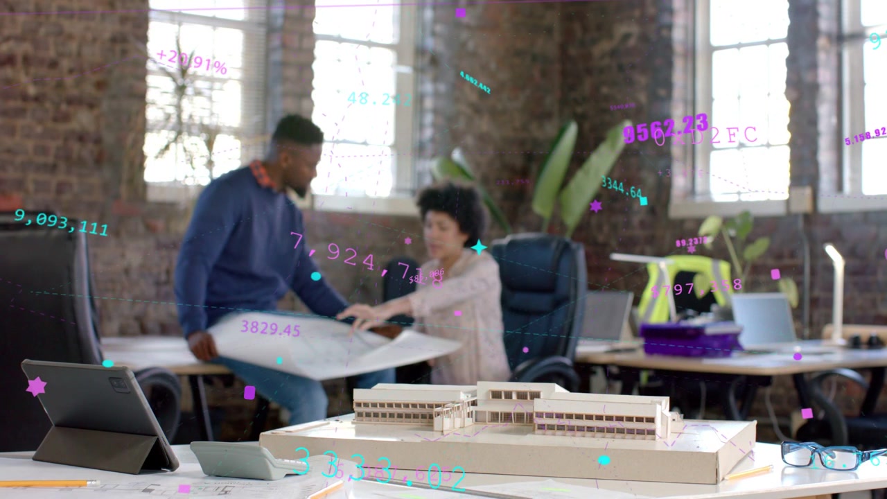 Diverse coworkers examining large rolled plans at loft office, pointing near scale model