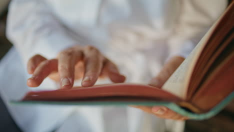 woman fingers holding book running pages closeup. adult reader enjoying hobby