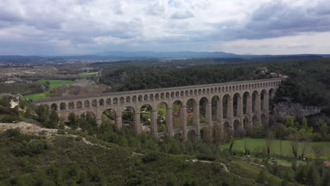 back aerial traveling over the largest stone aqueduct in the world roquefavour