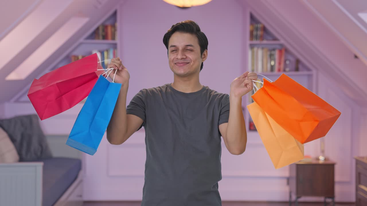 hombre indio feliz con bolsas de compras