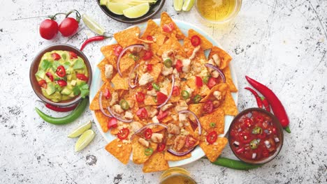 a plate of delicious tortilla nachos with melted cheese sauce  grilled chicken