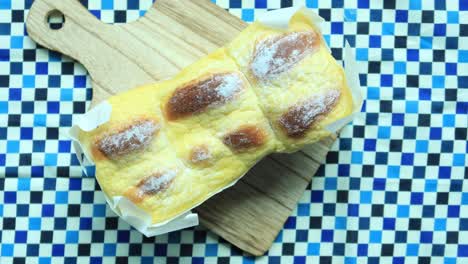 Close-up-of-cream-bun-bread-on-table-,