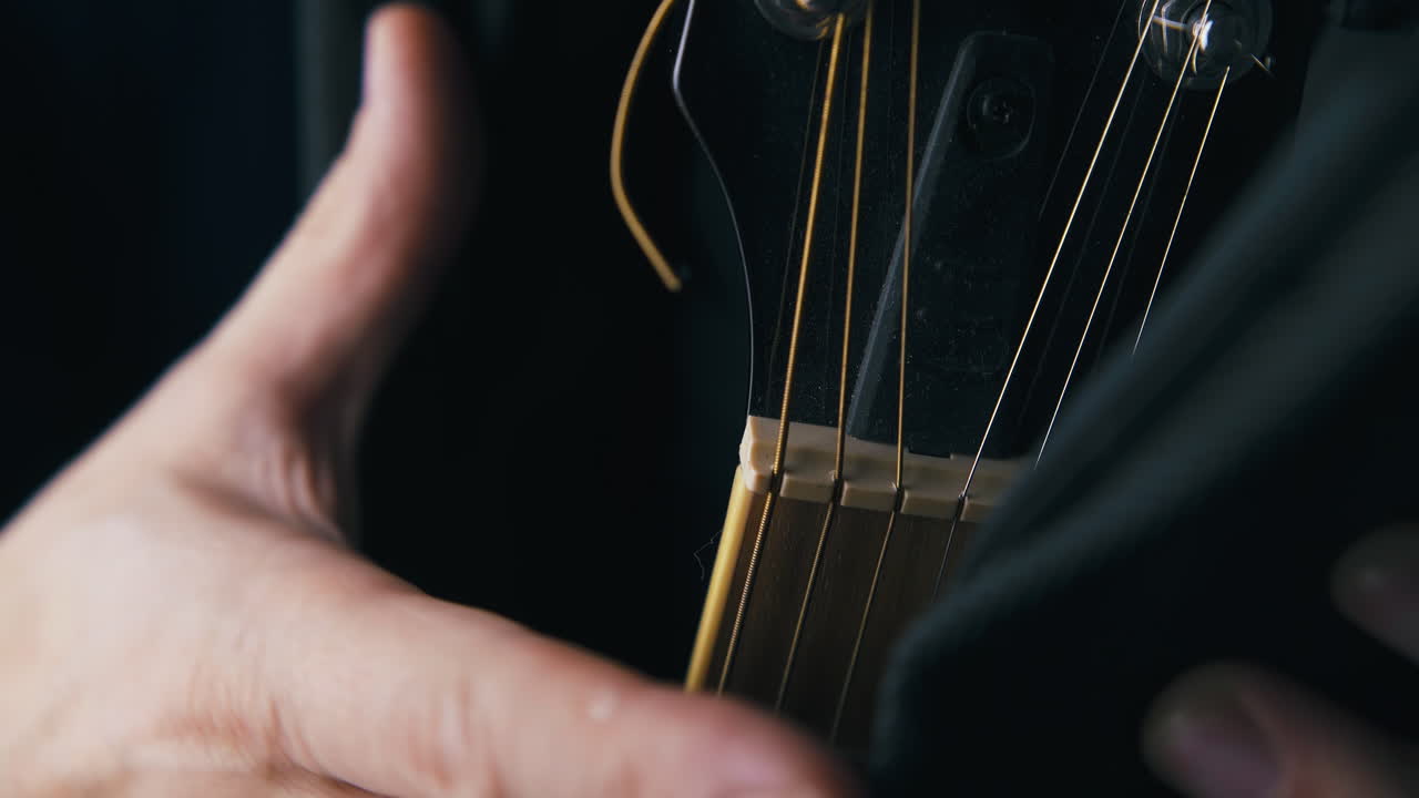 jazz guitarist opens black case with brown acoustic guitar