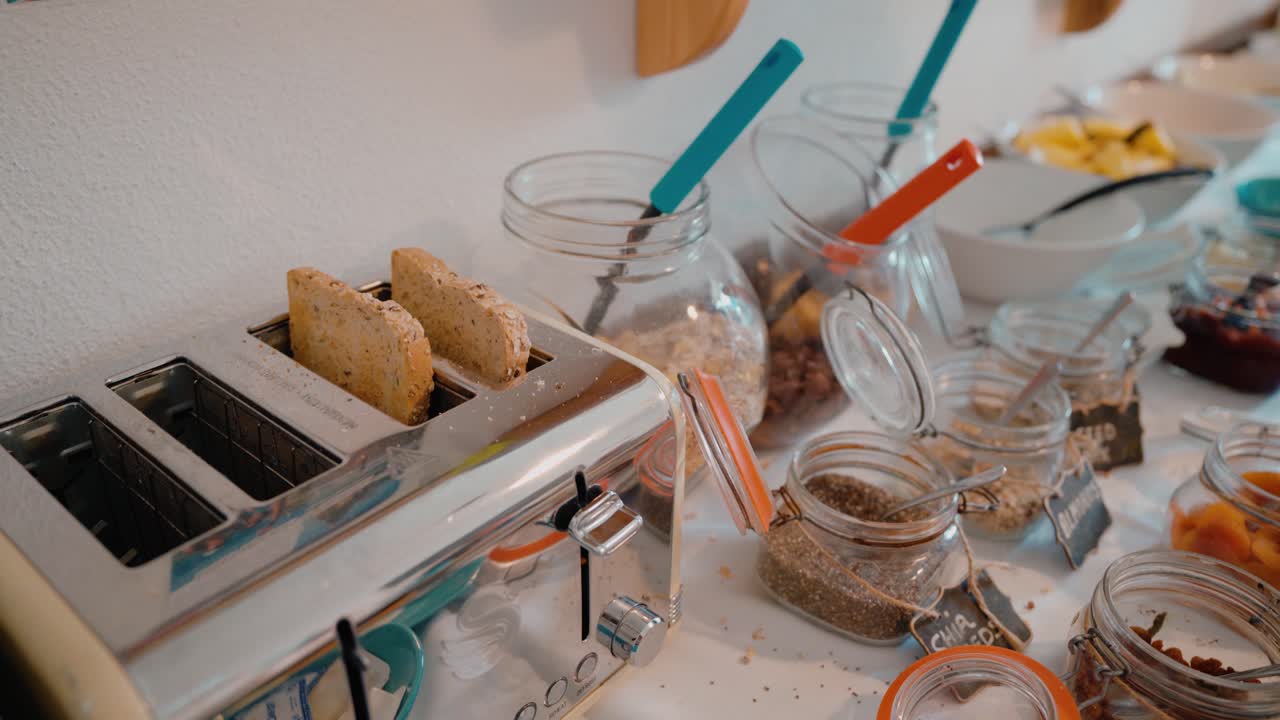 Breakfast buffet with a toaster and various food jars