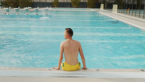 man relaxing by the pool