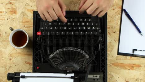 Person Typing on a Vintage Typewriter