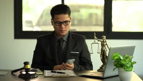 a corrupt judge or black market man. criminal. dirty judge counting dollars, the man holding us currency with justice scale and hammer with the laptop.