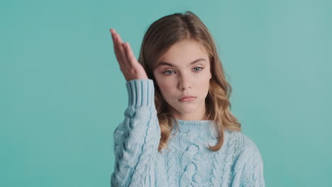 teenage caucasian girl looking bored in front of the camera.