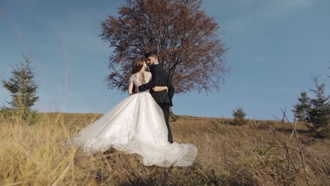 Frischvermählte.-Kaukasischer-Bräutigam-Mit-Braut-In-Der-Nähe-Eines-Schönen-Herbstbaums.-Hochzeitspaar