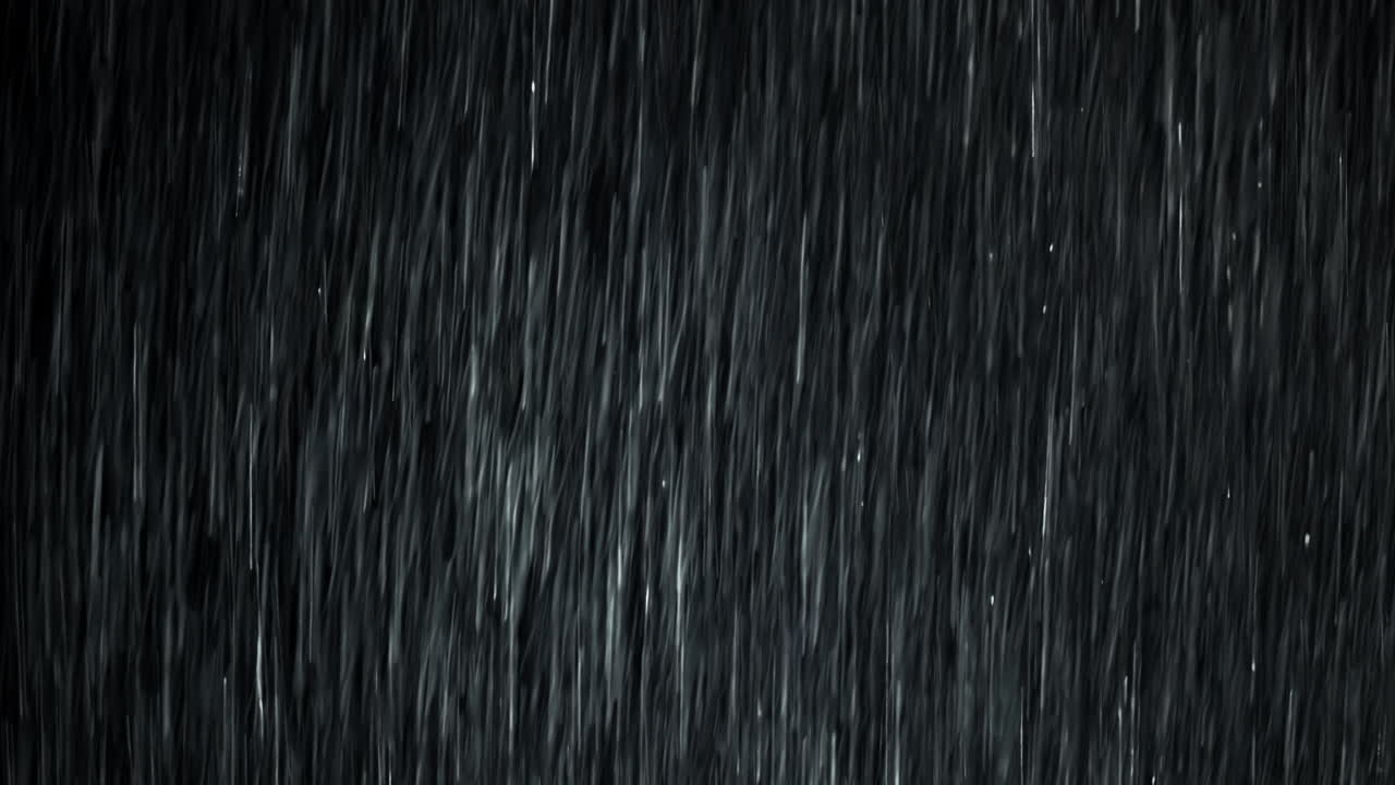 A heavy rain wall storms in front of the black screen in 4K loopable high-speed footage