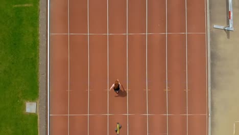 female athletic running on sports track 4k