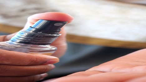 person using hand sanitizer spray