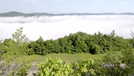 clouds and fog along with traffic on interstate 75 near jellico, tennessee in the cumberland mountains with drone video moving over dirt