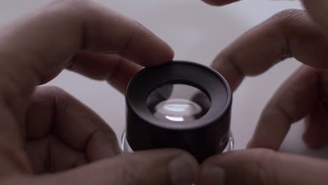 fingers tapping on loupe magnifier