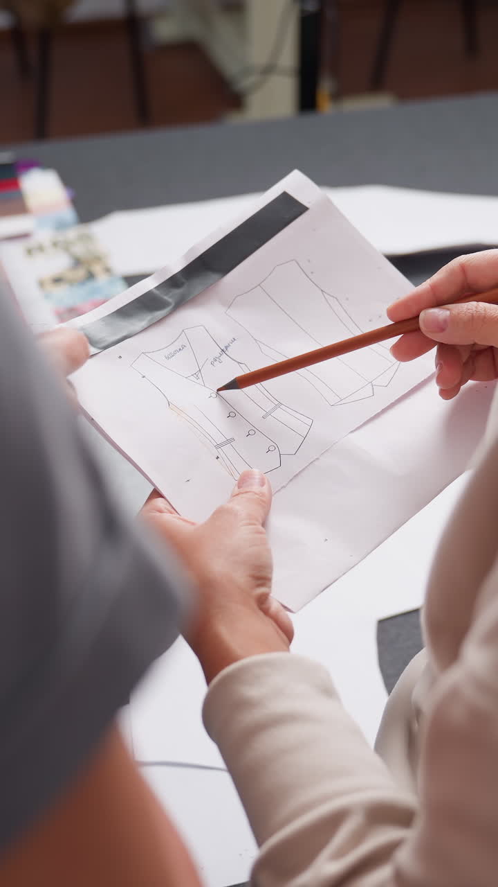 Detailed measurement planning, Careful alignment and planning for accurate fitting and design, Zoomed in view of pattern markings with blurred color samples in backdrop for precise measurement