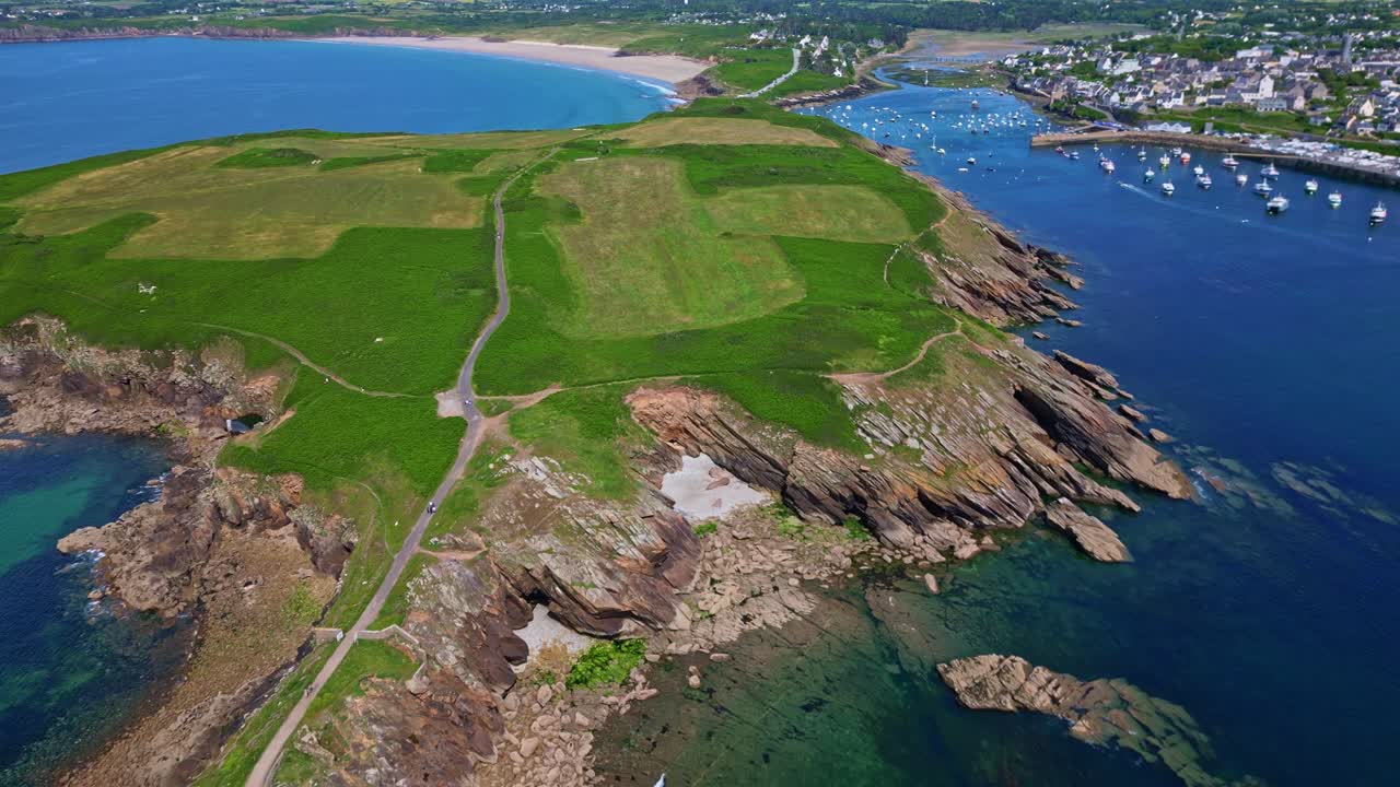 High drone shot flying over Kermorvan peninsula, fort, rocky cliffs, and the old harbor with blue sea - Brittany in France